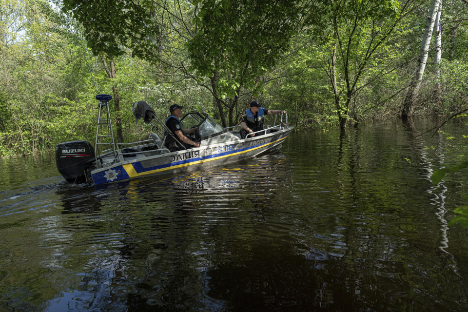 olice officers patrol area of Kakhovka reservoir on Dnipro river near Lysohirka, Ukraine, Thursday, May 18, 2023. Damage that has gone unrepaired for months at a Russian-occupied dam is causing dangerously high water levels along a reservoir in southern Ukraine. (AP Photo/Evgeniy Maloletka)