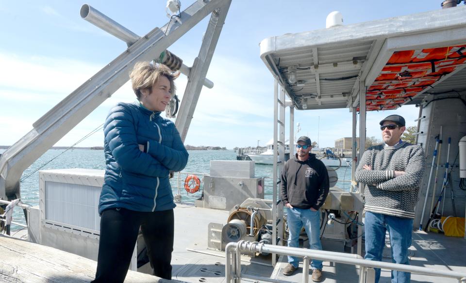 Massachusetts Gov. Maura Healey chats on Thursday with Capt. Peter Collins, right, and first mate James Missios aboard the research boat Tioga on a tour of the Woods Hole Oceanographic Institution in Woods Hole.