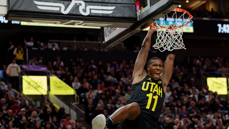 Utah Jazz guard Kris Dunn dunks the ball with an assist from Utah Jazz guard Jordan Clarkson at the Delta Center in Salt Lake City on Monday, Jan. 1, 2024.