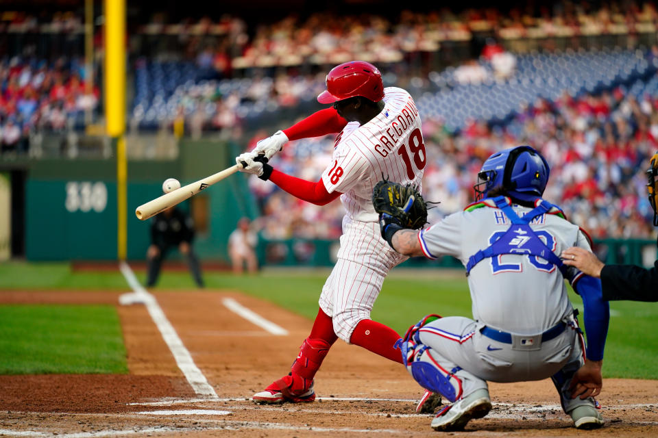 Philadelphia Phillies' Didi Gregorius hits an RBI single off Texas Rangers' Jon Gray during the first inning of a baseball game Tuesday, May 3, 2022, in Philadelphia. (AP Photo/Matt Rourke)