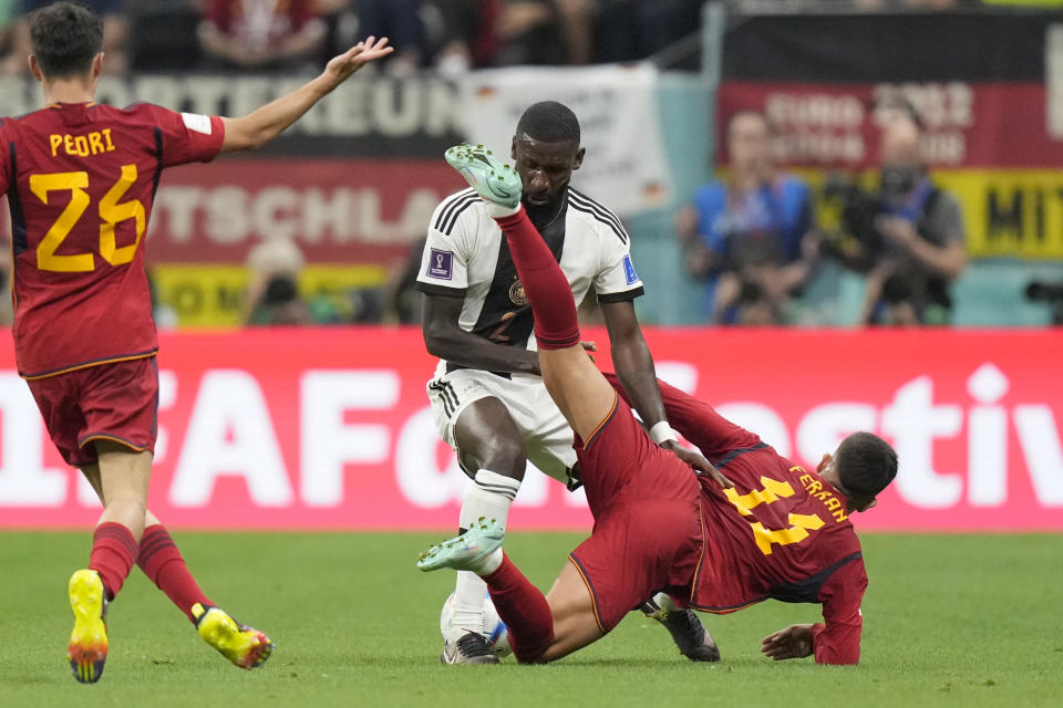 Germany's Antonio Ruediger fights for the ball with Spain's Ferran Torres, right, during the World Cup group E soccer match between Spain and Germany, at the Al Bayt Stadium in Al Khor , Qatar, Sunday, Nov. 27, 2022. (AP Photo/Matthias Schrader)