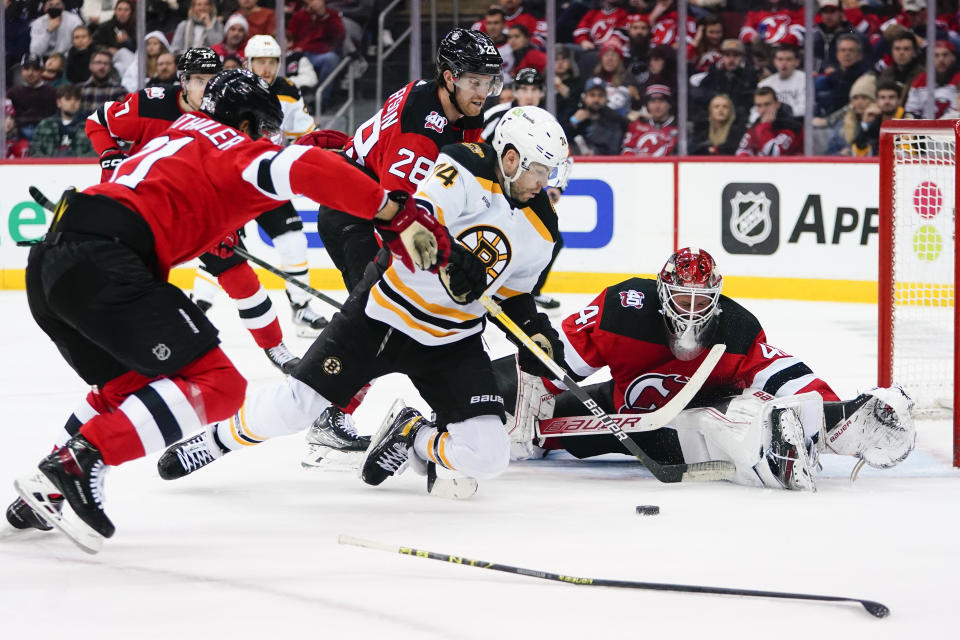 New Jersey Devils goaltender Vitek Vanecek (41) stops a shot on goal by Boston Bruins' Jake DeBrusk (74) during the second period of an NHL hockey game Wednesday, Dec. 28, 2022, in Newark, N.J. (AP Photo/Frank Franklin II)