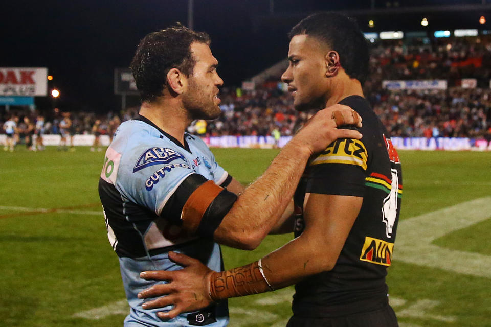 Pictured left, Sharks star Dale Finucane looks at the ear of Panthers flyer Stephen Crichton after an accidental head clash between the pair. 