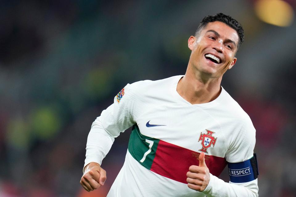 Cristiano Ronaldo smiles while running during a Portugal soccer match.