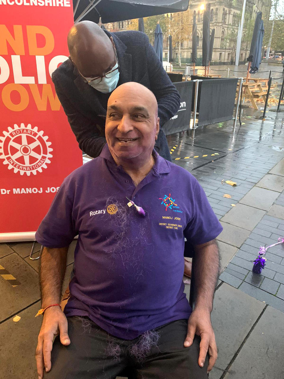 Dr Manoj Joshi, 68, shaved his moustache for the first time in 52 YEARS at Bradford City Hall to raise funds to eradicate polio. See SWNS story SWLEmoustache; A man who shaved his moustache to raise funds for a polio vaccine says his wife cant even recognise him - after he trimmed it for the first time in 52 YEARS. Dr Manoj Joshi, 68, says he had never shaved his moustache ever since he could grow one as a fresh faced 16-year-old but decided to chop it all off in a bid to eradicate polio. But after he chopped it off his shocked wife said she couldnt recognise him as shed never seen him without it in the 42 years they had been married. The grandfather-of-two joked that it would take a lawn mower to trim his luscious facial hair - which is older than the invention of the mobile phone. Dr Joshi, a proud Rotarian, which is a worldwide charitable society with over a million members worldwide, has been involved in what he calls acts of giving for his entire life. On World Polio Day (Saturday, Oct 24) he took centre stage at a park in front of Bradford City Hall to shave off his beloved moustache in an emotional day.