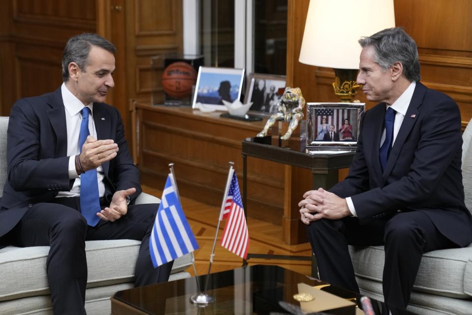 Greece's Prime Minister Kyriakos Mitsotakis, left, speaks with the US Secretary of State Antony Blinken during their meeting at Maximos Mansion in Athens, Greece, on Monday, Feb. 20, 2023. Blinken will be on a two-day trip in Athens, after his visit to Turkey, to meet with the country's leadership and launch the fourth round of the US-Greece Strategic Dialogue.(AP Photo/Thanassis Stavrakis)