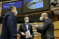 European Council President Charles Michel, right, speaks with European Commission's Head of Task Force for Relations with the United Kingdom Michel Barnier, center, and European Commissioner for Inter-institutional Relations and Foresight Maros Sefcovic prior to a report of last weeks EU summit during a plenary session at the European Parliament in Brussels, Wednesday, Oct. 21, 2020. (Olivier Hoslet, Pool via AP)