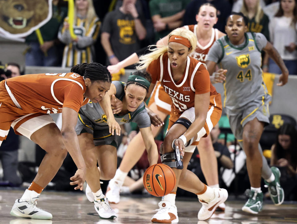 Baylor guard Jada Walker battles Texas forward Madison Booker, left, and Aaliyah Moore, right, for a loose ball in the second half of an NCAA college basketball game, Thursday, Feb. 1, 2024, in Waco, Texas. (Rod Aydelotte/Waco Tribune-Herald via AP)