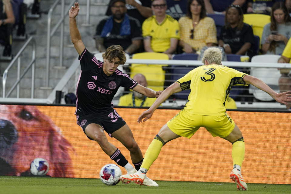 Inter Miami midfielder Benjamin Cremaschi (30) gets past Nashville SC defender Lukas MacNaughton (3) during the first half of an MLS soccer match Wednesday, May 17, 2023, in Nashville, Tenn. (AP Photo/George Walker IV)