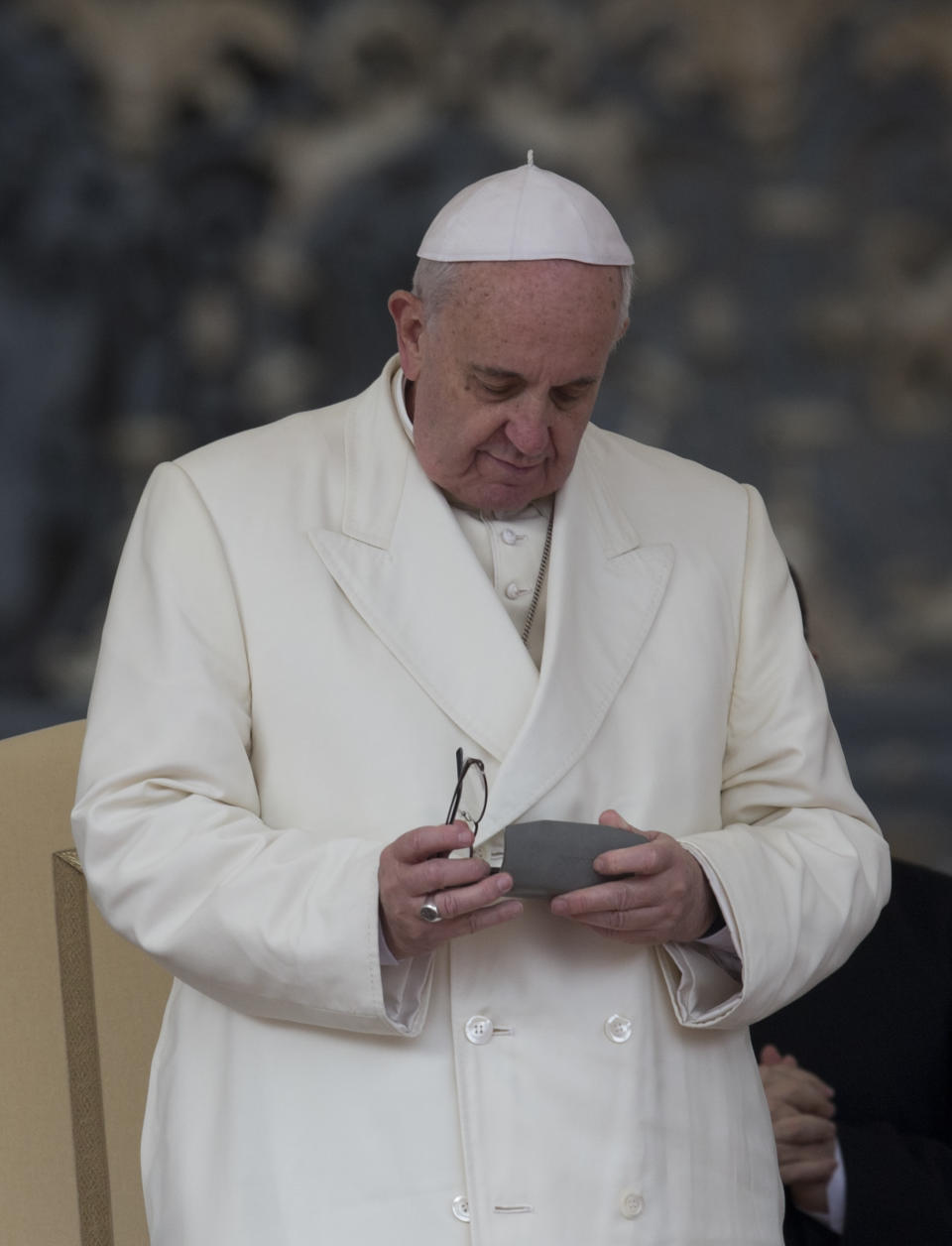 Pope Francis holds his glasses at the end of his weekly general audience in St. Peter's Square at the Vatican, Wednesday, Feb. 5, 2014. A U.N. human rights committee denounced the Vatican on Wednesday for “systematically” adopting policies that allowed priests to rape and molest tens of thousands of children over decades, and urged it to open its files on the pedophiles and the bishops who concealed their crimes. (AP Photo/Alessandra Tarantino)
