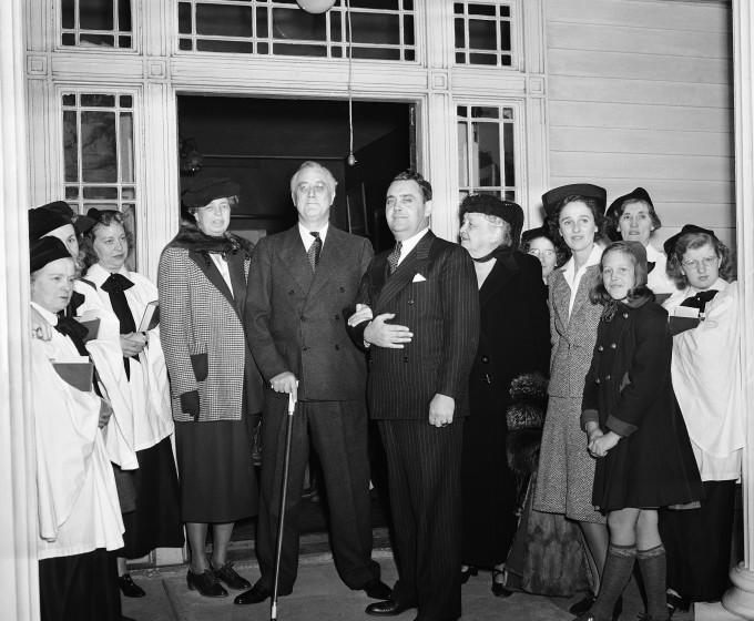 A prayer for a new peace in the old world and a continued peace in America President Franklin Roosevelt and his family 21 at Hyde Park, New York on Nov. 21, 1940 in a typical of service of thanksgiving. The prayer was offered by the Rev. Frank B. Wilson at St. James Episcopal Church, which the Roosevelt attended. Here, standing with the church choir after services, are (left to right) Mrs. Franklin D. Roosevelt, the president and his personal aide, Thomas Qualters, Mrs. Sara Roosevelt, Betsy Cushing Roosevelt, and her daughter, Sara Roosevelt. (AP Photo)