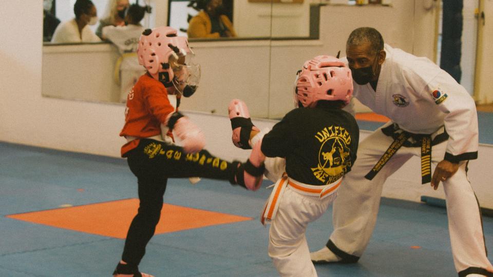 Dwayne McKinney watches two students spar at Unified Tae Kwon-Do on Scottsville Road.
