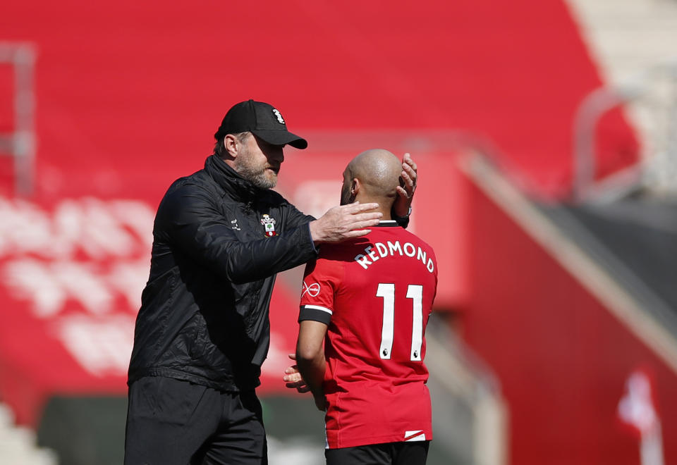 Southampton's manager Ralph Hasenhuettl, left, celebrates with Southampton's Nathan Redmond at the end of the English Premier League soccer match between Southampton and Burnley at St. Mary's Stadium in Southampton, England, Sunday, April 4, 2021. (Andrew Boyers/Pool via AP)
