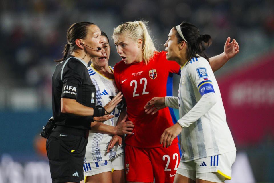 Philippines' Hali Long, right, Angela Beard, second left, and Norway's Sophie Roman Haug, second right, talk to Canadian referee Marie-Soleil Beaudoin during the Women's World Cup Group A soccer match between Norway and Philippines at Eden Park stadium in Auckland, New Zealand, Sunday, July 30, 2023. (AP Photo/Abbie Parr)