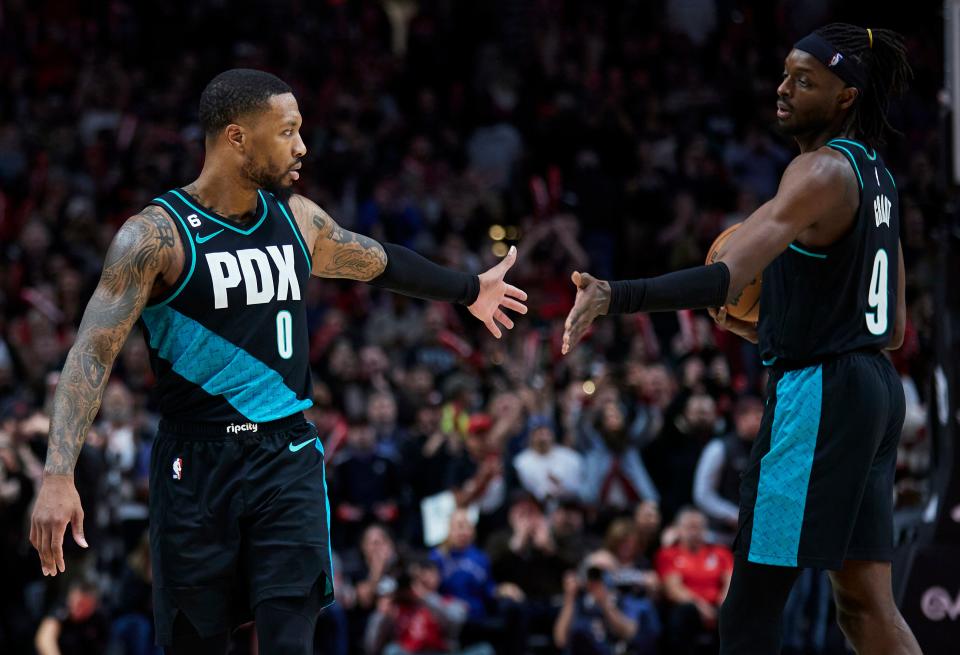 Portland Trail Blazers guard Damian Lillard, left, and forward Jerami Grant celebrate at the end of the team's NBA basketball game against the San Antonio Spurs in Portland, Ore., Tuesday, Nov. 15, 2022. (AP Photo/Craig Mitchelldyer)