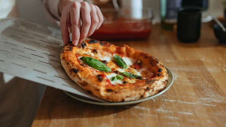 transfering pizza using pizza peel