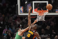 Boston Celtics forward Jayson Tatum (0) has his shot blocked by Atlanta Hawks center Clint Capela (15) during the first half of an NBA basketball game Thursday, March 28, 2024, in Atlanta. (AP Photo/John Bazemore)