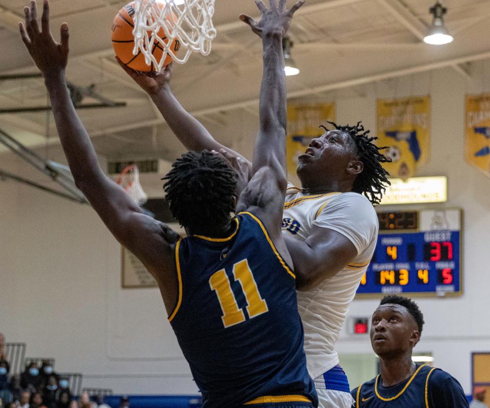 Auburndale's Nehemiah Turner goes up for a shot against Winter Haven's Dylan James.