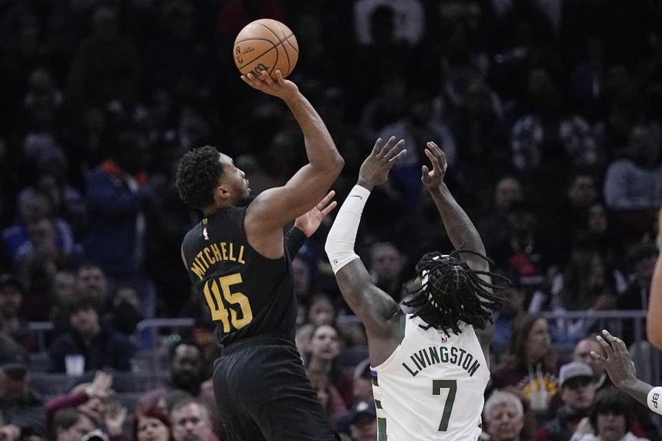 Cleveland Cavaliers guard Donovan Mitchell (45) shoots over Milwaukee Bucks forward Chris Livingston (7) during the second half of an NBA basketball game Wednesday, Jan. 17, 2024, in Cleveland. (AP Photo/Sue Ogrocki)