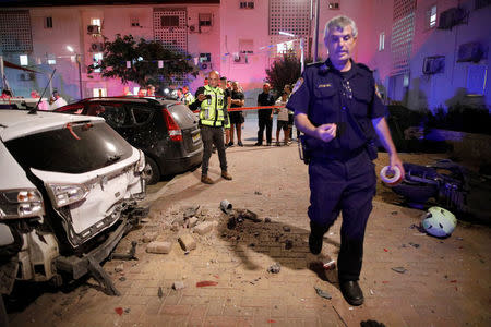 An Israeli policeman walks next to the scene where a rocket exploded in the southern city of Sderot, Israel August 8, 2018. REUTERS/Amir Cohen