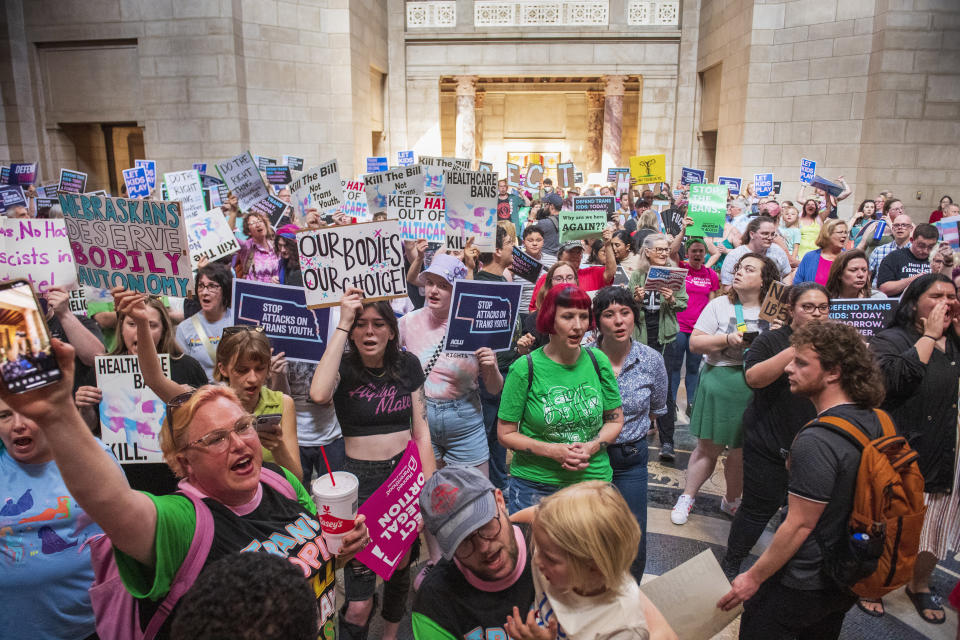 FILE - Protesters chant, "One vote to save our lives," as they are heard in the legislative chamber during a final reading on a bill that combined a 12-week abortion ban with a measure to restrict gender-affirming care for people under 19, May 16, 2023, at state Capitol in Lincoln, Neb. Regulations tied to a Nebraska law passed in 2023 restricting gender-affirming care for minors were approved Tuesday, March 12, 2024, by Gov. Jim Pillen, and they largely mirror temporary regulations adopted last October — including a seven-day waiting period to start puberty blocking medications or hormone treatments. (Kenneth Ferriera/Lincoln Journal Star via AP, File)