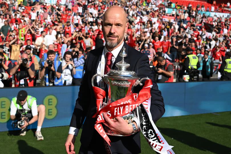 Erik ten Hag, manager of Manchester United looks on with the FA Cup trophy after the Emirates FA Cup Final match between Manchester City and Manchester United at Wembley Stadium on May 25, 2024 in London, England.