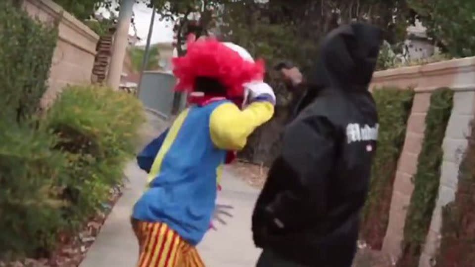 'Don't run b***h': The gun-wielding man smacked the clown across the face.