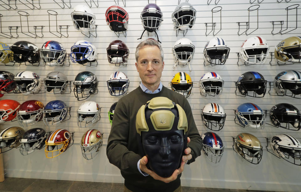 In this photo taken May 23, 2019, Dave Marver, CEO of VICIS, a Seattle-based company that makes football helmets, poses for a photo in Seattle as he holds the company's latest offering, the ULTIM cap. VICIS announced on Monday, July 1, the cap is intended for use with youth flag football and the quickly expanding competitive 7-on-7 football played during the offseason for youth and high school programs. (AP Photo/Ted S. Warren)