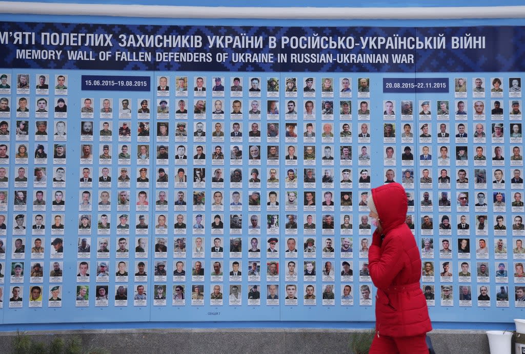 A woman walks past the Wall of Remembrance for those who have died fighting for Ukraine in the ongoing Donbas conflict (Getty Images)