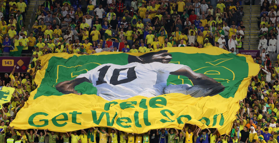 Brazil fans hold a banner showing support for former Brazil player Pele during the match between Brazil and South Korea. (Michael Steele/Getty Images)
