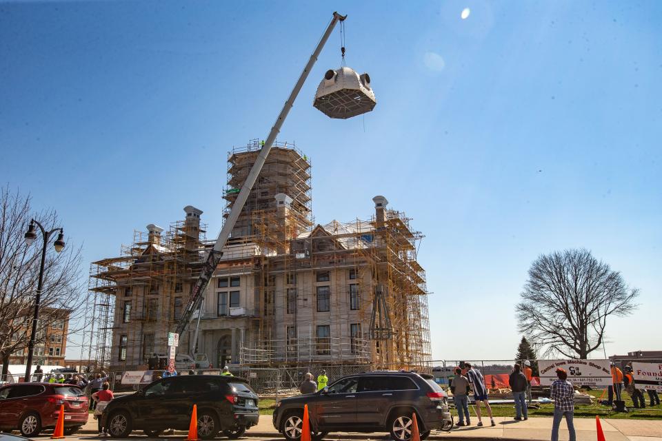 A new dome is lifted atop the Marshall County courthouse in Marshalltown in 2020 to replace the one damaged in a 2018 tornado. The restored courthouse was rededicated Saturday.