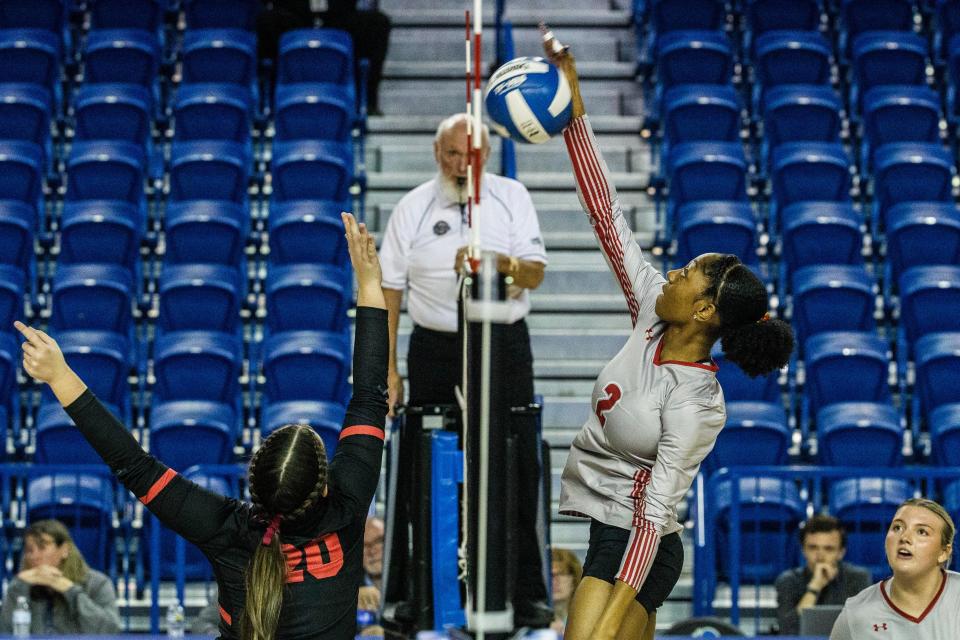 Smyrna senior Elise Carter (2) jumps to spike the ball against Ursuline Academy sophomore Hayley Timmons (20) during the DIAA Girls Volleyball Tournament championship game at the Bob Carpenter Center in Newark, Thursday, Nov. 16, 2023. Smyrna won 3-1.