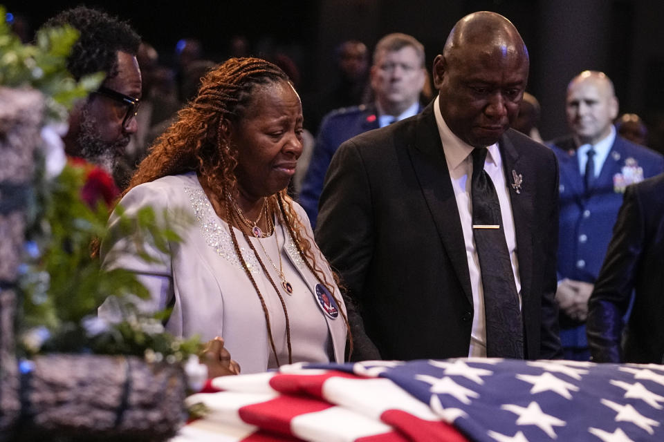 Chantemekki Fortson, left, the mother of slain airman Roger Fortson and Trial lawyer Benjamin Crump stand at his casket during his funeral at New Birth Missionary Baptist Church, Friday, May 17, 2024, near Atlanta. (AP Photo/Brynn Anderson)