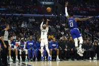 Utah Jazz guard Mike Conley, center, shoots as Los Angeles Clippers guard Paul George defends during the first half of an NBA basketball game Tuesday, March 29, 2022, in Los Angeles. (AP Photo/Mark J. Terrill)