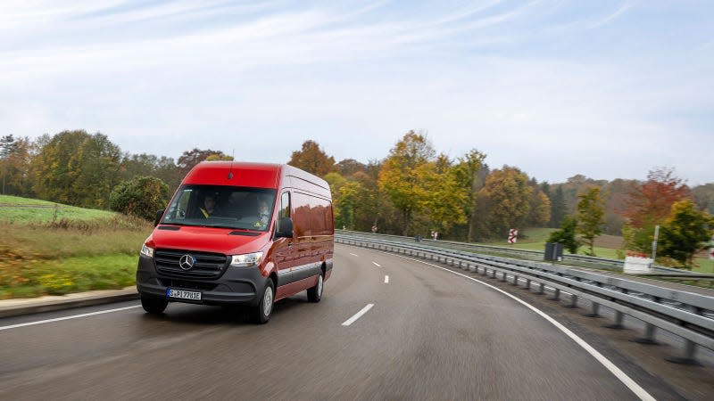 A photo of the front end of an electric Mercedes Sprinter van driving on a highway. 