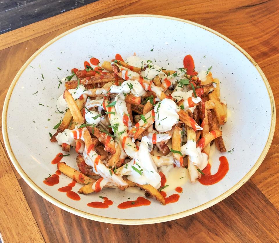 Rally fries from B2 Bistro + Bar in Red Bank, topped with house-made hot sauce, ranch, herbs and cheese sauce.