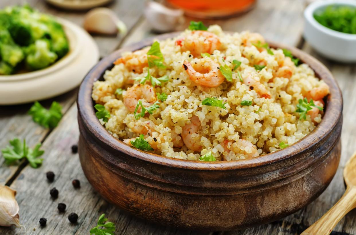 quinoa with shrimp and parsley on a dark wood background. the toning. selective focus