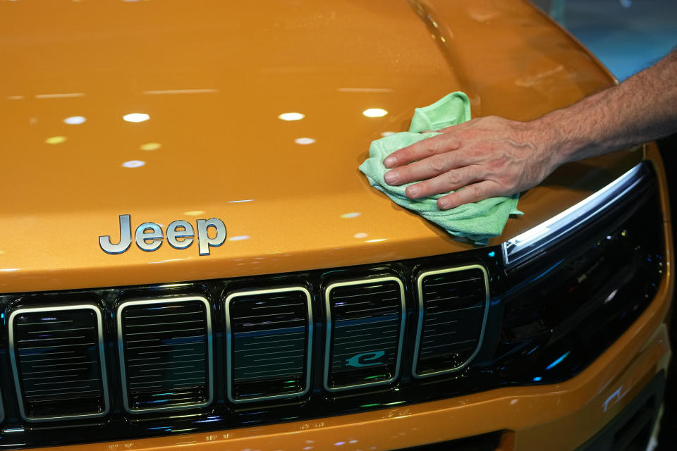 A man cleans the electric-powered Jeep Avenger SUV at the Paris Car Show Monday, Oct. 17, 2022 in Paris. Europe is leading the charge into electric vehicles as battery powered cars break out of their niche market of first adopters and enter the mainstream with increasing market share that's forecast to grow strongly as the EU pushes to phase out internal combustion engine vehicles by 2035 (AP Photo/Michel Euler)