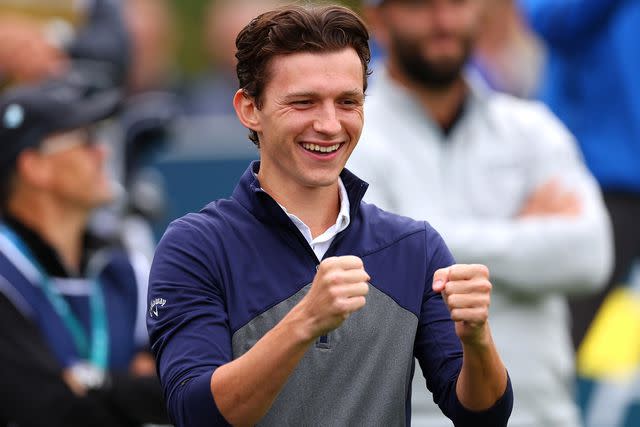 <p>Andrew Redington/Getty </p> Tom Holland gestures on the 1st hole during the Pro-Am prior to the BMW PGA Championship at Wentworth Golf Club on September 13, 2023 in Virginia Water, England.