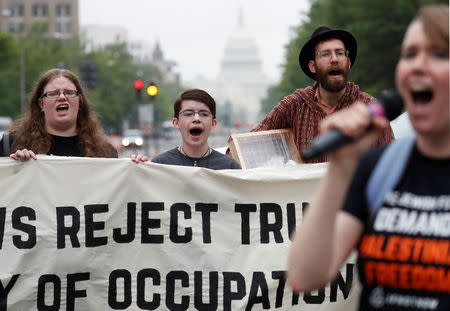 Melissa Knapp, Avi, and David Bronstein protest outside of Trump International Hotel against the new U.S. Embassy opening in Jerusalem in Washington, U.S., May 14, 2018. REUTERS/Leah Millis