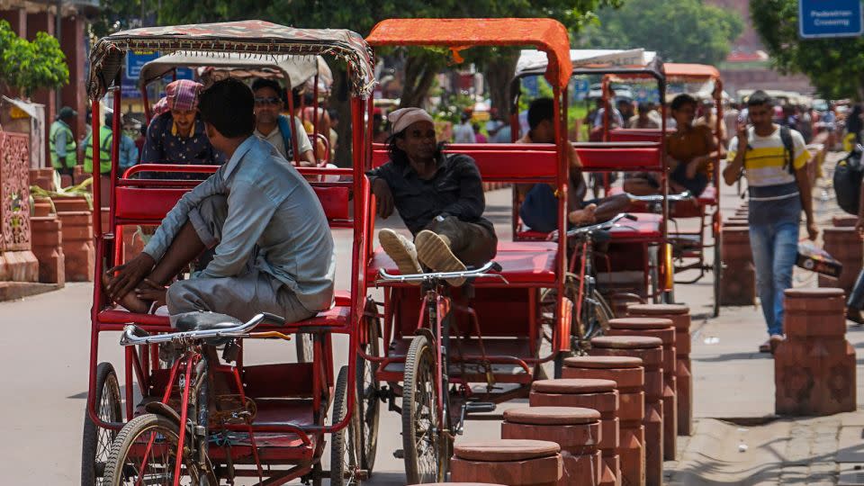 Rickshaw pullers rest on a street in Chandni Chowk, Old Delhi, India on August 6, 2023. - Pradeep Dambarage/Nurphoto/Getty Images