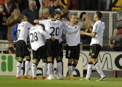 Valencia's players celebrate a goal during their Spanish La Liga match against Betis, on April 22, at the Mestalla stadium in Valencia. Valencia play Malaga next, at Estadio La Rosaleda, on Sunday