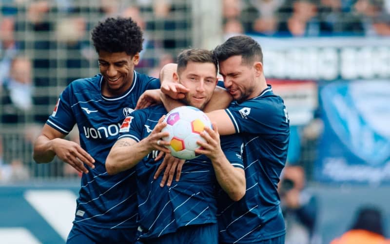 Bochum's Maximilian Wittek (C) celebrates with teammates Bernardo (L) and Kevin Stoeger after scoring their side's first goal during the German Bundesliga soccer match between VfL Bochum and RB Leipzig at Vonovia Ruhrstadion. Bernd Thissen/dpa