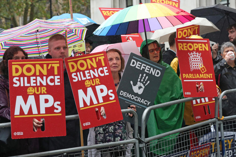 Protesters stand outside the Supreme Court, where judges judges that Boris Johnson broke the law when he decided to suspend Parliament.