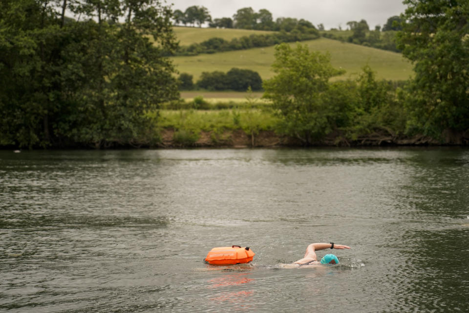 Susan Barry, member of the open water swimming group Henley Mermaids, swims in the river Thames, in Henley-on-Thames, England, Friday, June 14, 2024. Britain has become notorious as a place where a casual swim could lead to an extended visit to the toilet, if not the hospital. A torrent of news on dirty water has spilled into next month's election to determine which party controls government for the next four or five years. (AP Photo/Alberto Pezzali)