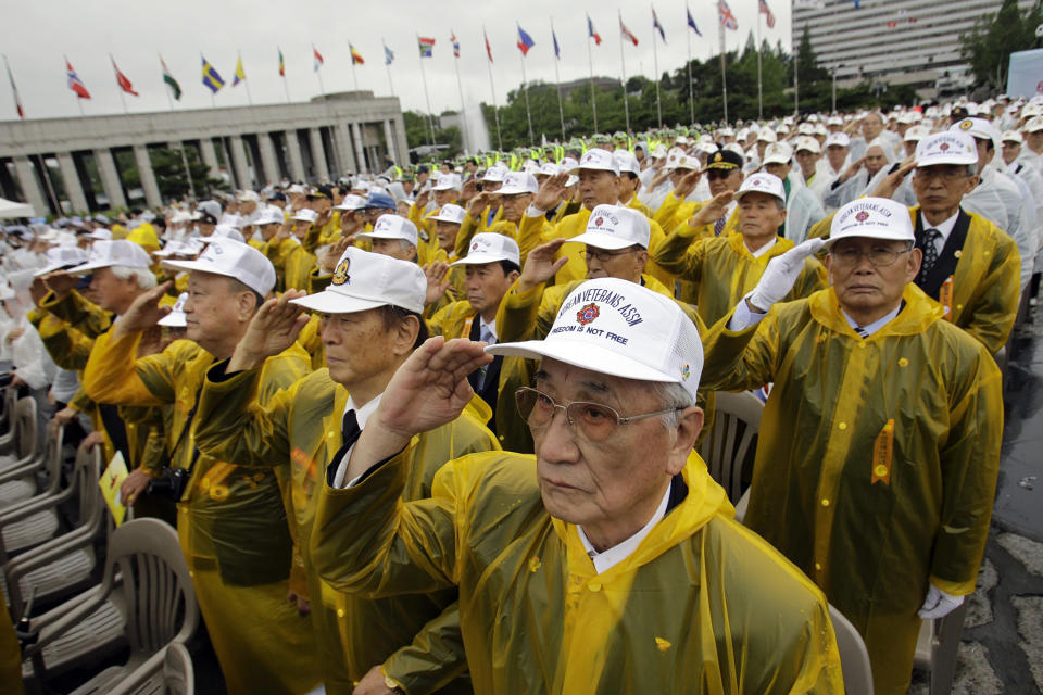 FILE - In this June 25, 2011, file photo, Korean War veterans salute during a ceremony to mark the 61st anniversary of the outbreak of the Korean War at Korea War Memorial Museum in Seoul, South Korea. On both sides of the world's most heavily armed border Thursday, June 25, 2020, solemn ceremonies will mark the 70th anniversary of the outbreak of a war that killed and injured millions, left large parts of the Korean Peninsula in rubble and technically still continues. (AP Photo/Lee Jin-man, File)