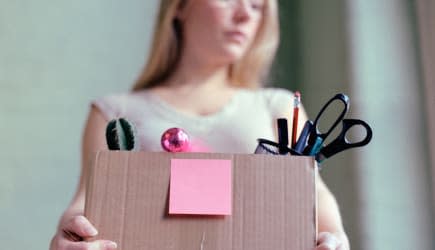 Woman carrying box of stationery