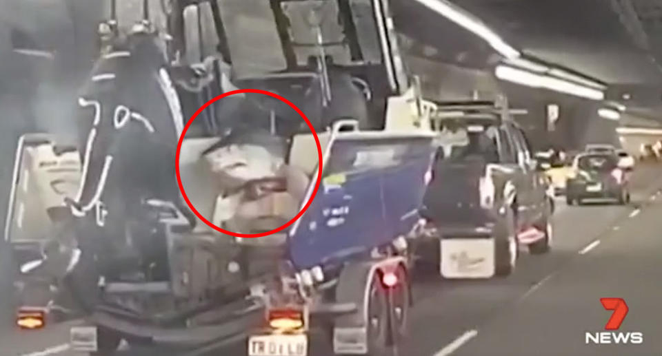 Motorists were baffled to spot the shark hanging from the back of the men’s boat. Source: 7News