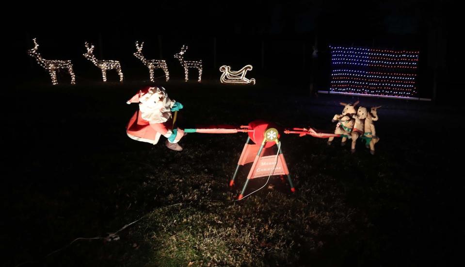 Santa on a teeter totter with his reindeer is one of the many decorations in the yard of Dan and Rose Rambacher  Friday in Sagamore Hills. The couple raised over $37,000 for St. Jude's Hospital in donations from admirers of their Christmas light display this season.