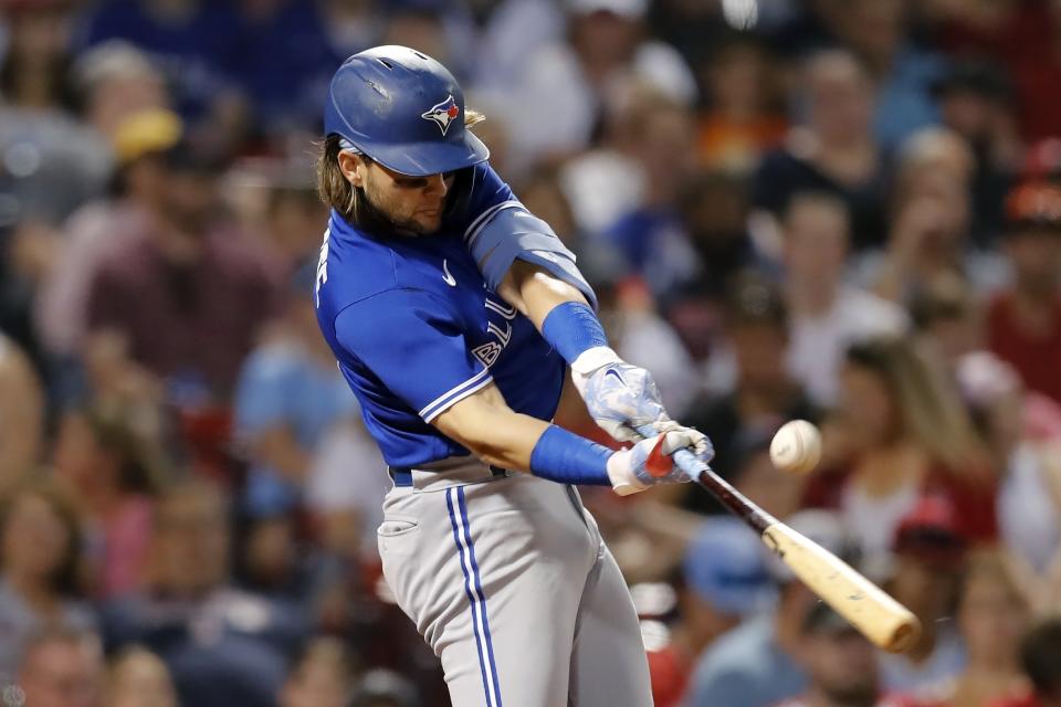 Toronto Blue Jays' Bo Bichette hits an RBI single during the fifth inning of the team's baseball game against the Boston Red Sox, Friday, July 22, 2022, in Boston. (AP Photo/Michael Dwyer)